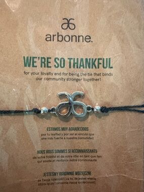 Arbonne Silver Logo Bracelet — Black Cord